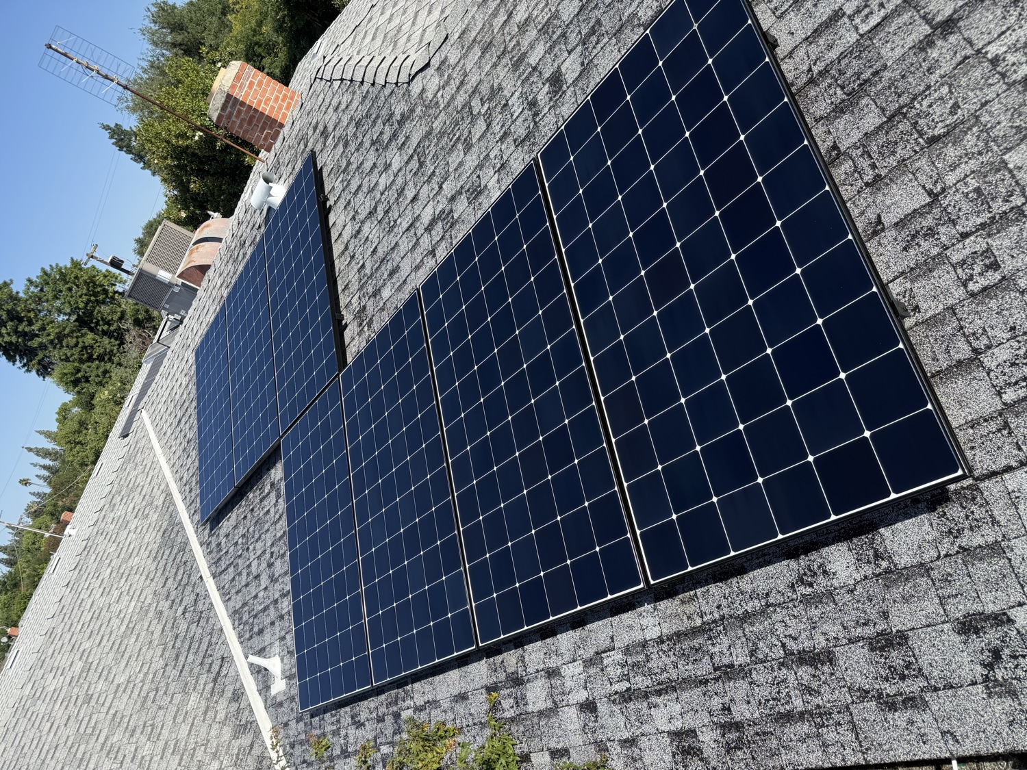 Freshly cleaned solar panels on a Fresno rooftop by Garcia's Roof Cleaning Services